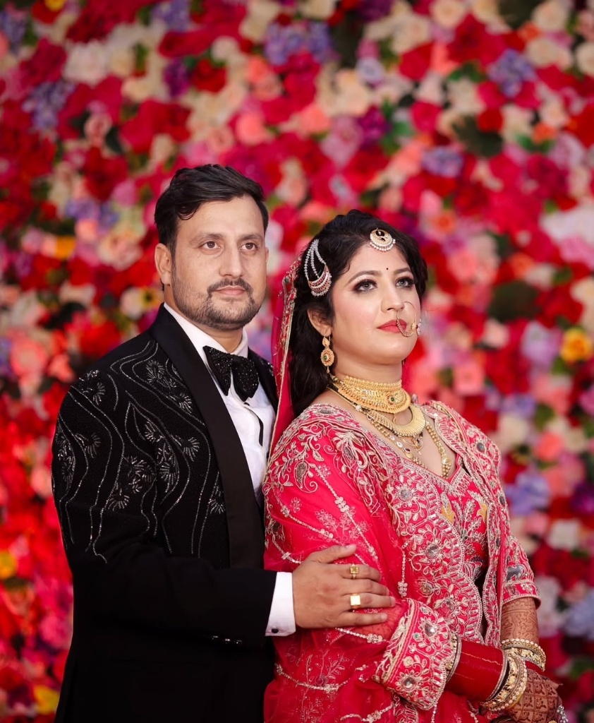Opulent couple portrait against floral backdrop